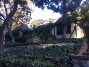 This Storybook has rolled eaves, half timbering as seen in Tudor style architecture and wood shingles. It also utilizes a lot of greenery to give the illusion that the house is in a traditionally wooded area when it's actually located in Los Angeles. 
