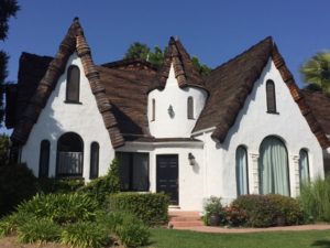 This Storybook in Encino is beautifully preserved and features many of the distinctive elements to look for, including: steep gables, wood shingles, turret entrance, stucco exterior, rounded windows, rounded eaves and irregular roof pattern. Looks like the front door has been changed out though. 